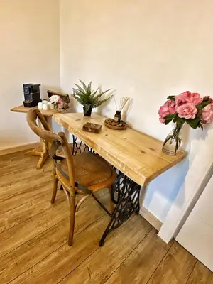 a wooden table with a vase of flowers on it at U PASTURELLU in Pioggiola