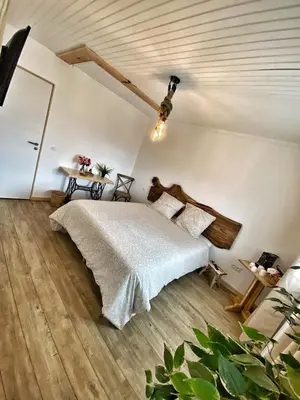 a bedroom with a bed and a wooden floor at U PASTURELLU in Pioggiola