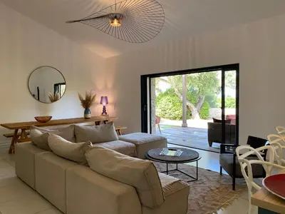 a living room with a couch and a table at Villa de standing et vue mer Porto Vecchio in Porto-Vecchio
