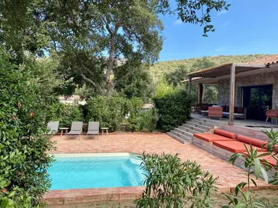 a swimming pool in a yard with a house at Villa de standing et vue mer Porto Vecchio in Porto-Vecchio
