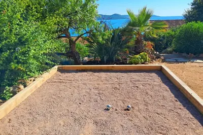 two golf balls sitting on the sand in a garden at Marina - Exceptional Sea View Ruppione - by TGB in Pietrosella