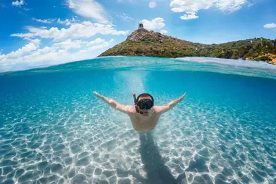 a person floating in the water in the ocean at Marina - Exceptional Sea View Ruppione - by TGB in Pietrosella