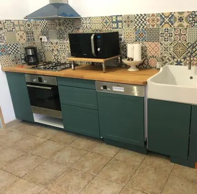 a kitchen with a counter with a microwave and a sink at Casadimela in Mela