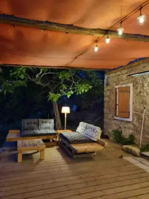 a patio with a couch and a table and a bench at Casadimela in Mela