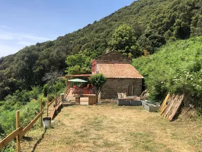 a small house in the middle of a mountain at Casadimela in Mela