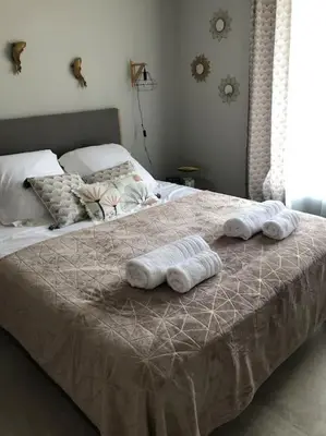 a bedroom with a bed with towels on it at Villa neuve avec piscine in Bonifacio
