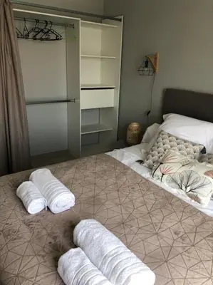two towels are laying on a bed in a bedroom at Villa neuve avec piscine in Bonifacio