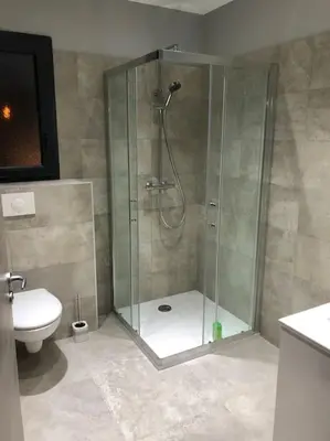 a bathroom with a shower and a toilet at Villa neuve avec piscine in Bonifacio