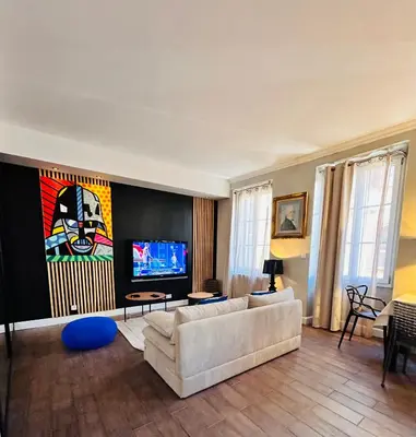 a living room with a couch and a tv at Appartement COSY centre Ajaccio in Ajaccio