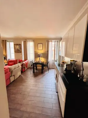 a kitchen and living room with a couch and a table at Appartement COSY centre Ajaccio in Ajaccio
