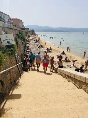 a group of people walking on a beach at Appartement COSY centre Ajaccio in Ajaccio