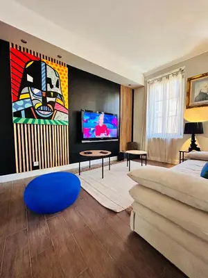 a living room with a couch and a tv at Appartement COSY centre Ajaccio in Ajaccio