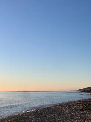 a beach with a large body of water at Appartement les pieds dans l'eau in Solaro