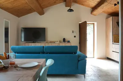 a living room with a blue couch and a table at Résidence Vista Blu in Conca