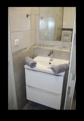 a bathroom with a sink and a mirror at Chez Céline & Rudi in Moriani Plage