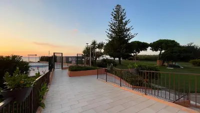 a walkway with a fence next to a pool at Chez Céline & Rudi in Moriani Plage