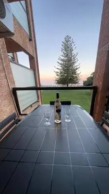 a bottle of wine sitting on a table with two wine glasses at Chez Céline & Rudi in Moriani Plage