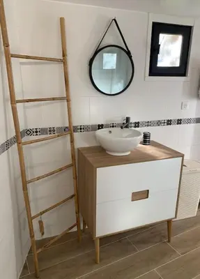 a bathroom with a sink and a mirror at Entre Mer et Montagne in Sartène