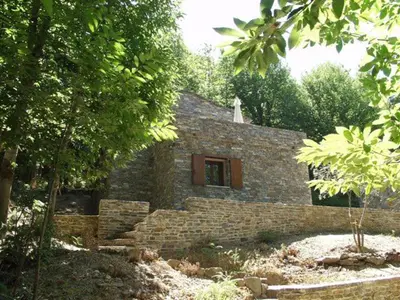 a stone house with a window in the middle of trees at HAUTE CORSE CENTRE CORSE CASTAGNICCIA Gîte de PETRERA 1 CASABIANCA in Casabianca