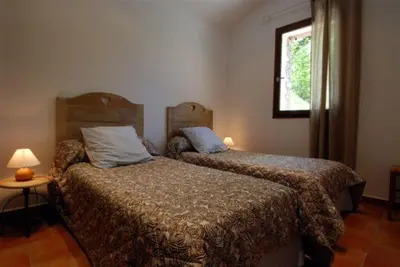 a bedroom with two beds and a window at HAUTE CORSE CENTRE CORSE CASTAGNICCIA Gîte de PETRERA 1 CASABIANCA in Casabianca
