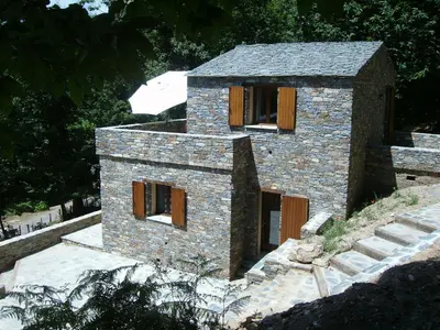 a stone house with wooden shutters on it at HAUTE CORSE CENTRE CORSE CASTAGNICCIA Gîte de PETRERA 1 CASABIANCA in Casabianca