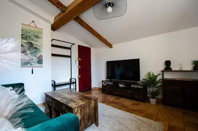 a living room with a couch and a tv at Charmant T2 au Cœur d'Ajaccio - Parking & AC in Ajaccio