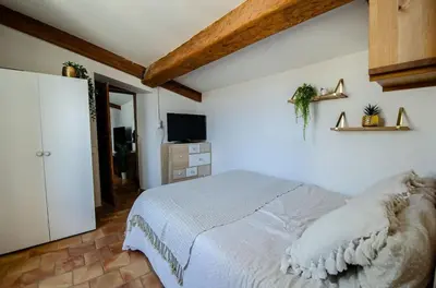 a bedroom with a bed and a television in it at Charmant T2 au Cœur d'Ajaccio - Parking & AC in Ajaccio