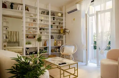 a living room with a couch and a table at Casamea - Apt Spacieux, Clim, Famille & Cabane in Ajaccio