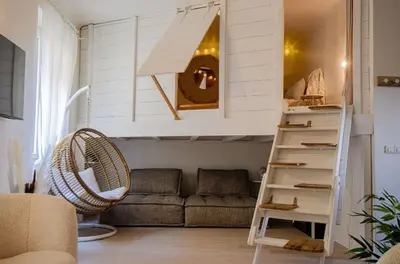 a living room with a loft bed and a couch at Casamea - Apt Spacieux, Clim, Famille & Cabane in Ajaccio