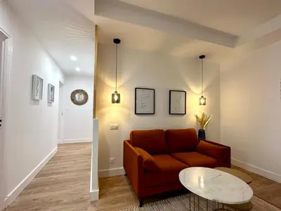 a living room with a couch and a table at Magnifique T3 équipé et climatisé centre Ajaccio idéal 4 personnes in Ajaccio