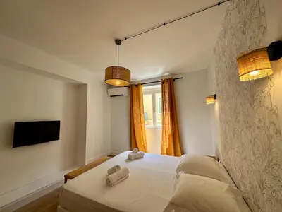 a bedroom with a bed with two towels on it at Magnifique T3 équipé et climatisé centre Ajaccio idéal 4 personnes in Ajaccio