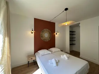 a bedroom with a bed with two towels on it at Magnifique T3 équipé et climatisé centre Ajaccio idéal 4 personnes in Ajaccio