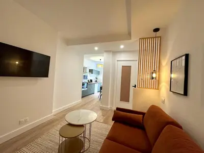 a living room with a couch and a table at Magnifique T3 équipé et climatisé centre Ajaccio idéal 4 personnes in Ajaccio