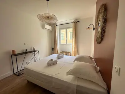 a bedroom with a bed with two towels on it at Magnifique T3 équipé et climatisé centre Ajaccio idéal 4 personnes in Ajaccio