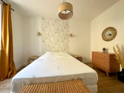 a bedroom with a large bed and a window at Magnifique T3 équipé et climatisé centre Ajaccio idéal 4 personnes in Ajaccio