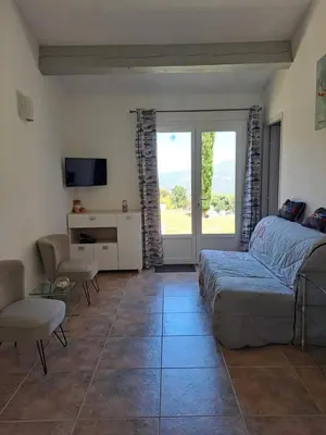 a bedroom with a bed and a desk and a television at Villa Cutalello coté montagne Calenzana in Calenzana