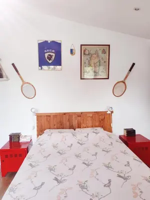 a bedroom with a bed and two red night stands at Casa Davia. Studio indépendant meublé. in Furiani
