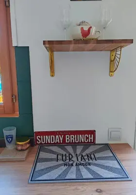 a welcome mat on the floor of a room with a sun day brunch sign at Casa Davia. Studio indépendant meublé. in Furiani
