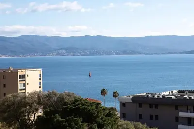 a sailboat in the water in a large body of water at CAPO FENO AJACCIO in Ajaccio