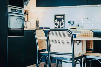 a kitchen with chairs and a table and a counter at CAPO FENO AJACCIO in Ajaccio