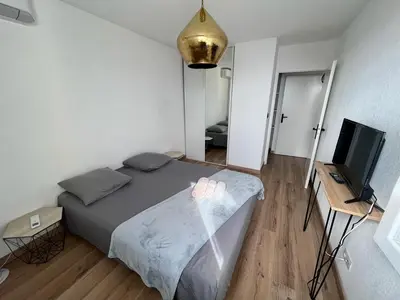 a bedroom with a bed and a flat screen tv at CAPO FENO AJACCIO in Ajaccio