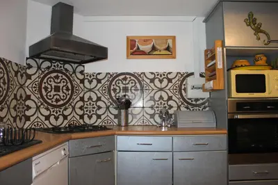 a kitchen with a stove and a microwave at Les hauts de Frisella in Monacia-dʼAullène