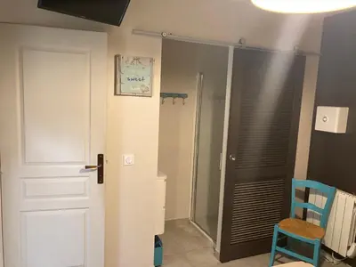 a bathroom with a shower and a toilet and a door at Les hauts de Frisella in Monacia-dʼAullène