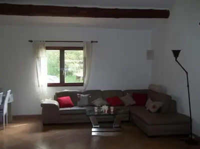 a living room with a couch and a table at QUIET COTTAGE NEAR CITY CENTER in Porto-Vecchio