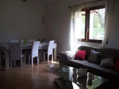 a living room with a couch and a table at QUIET COTTAGE NEAR CITY CENTER in Porto-Vecchio