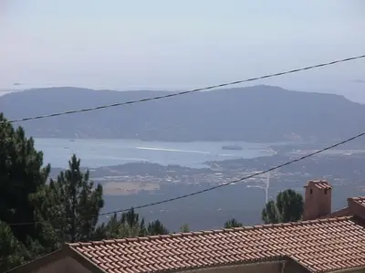 a view of the ocean from the roofs of houses at Fraîcheur & calme en Montagne, 30minutes de la mer in Porto-Vecchio