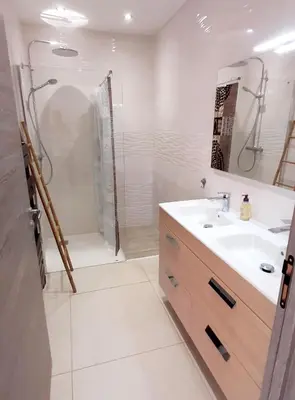 a white bathroom with a sink and a shower at Bel appartement Corse côte Est in Morta
