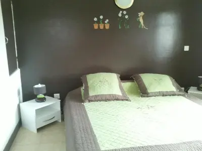 a bedroom with a bed and a black wall at La Corse mer turquoise et sable fin in Poggio-Mezzana