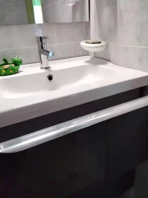 a white sink in a bathroom with a mirror at La Corse mer turquoise et sable fin in Poggio-Mezzana