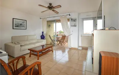a living room with a couch and a table at Cozy Apartment In Ajaccio With Wifi in Ajaccio